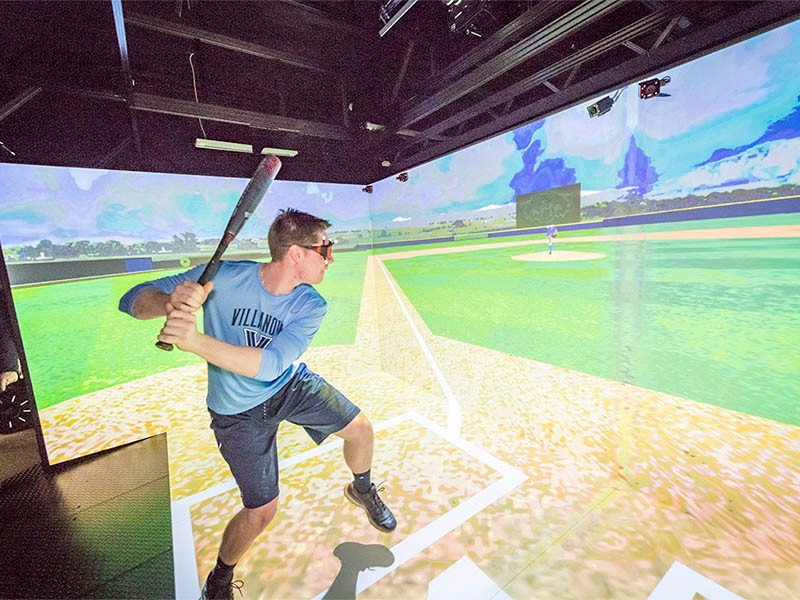A student in a baseball simulator