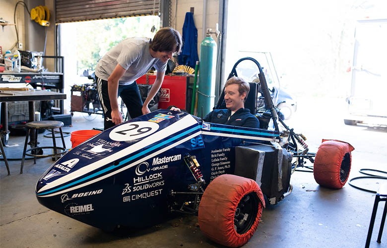 students in race car