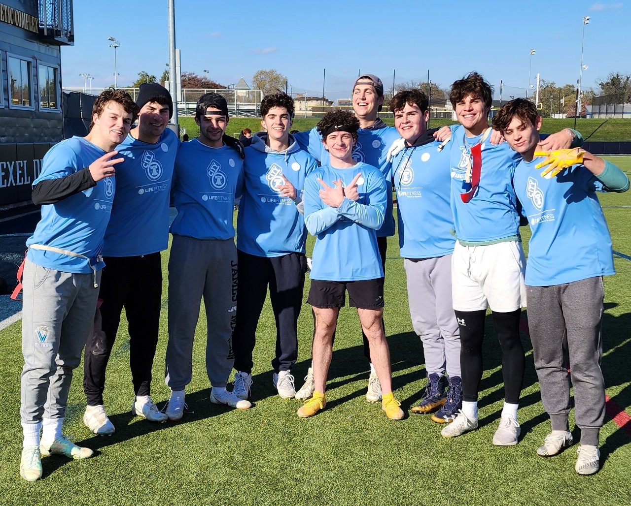 Male students posing for flag football champion photo