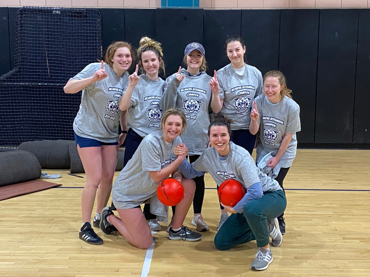 Female students posing for dodgeball champion photo