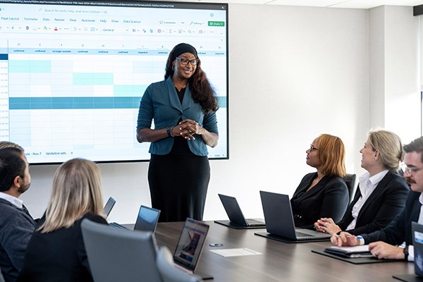 woman presenting in front of board room