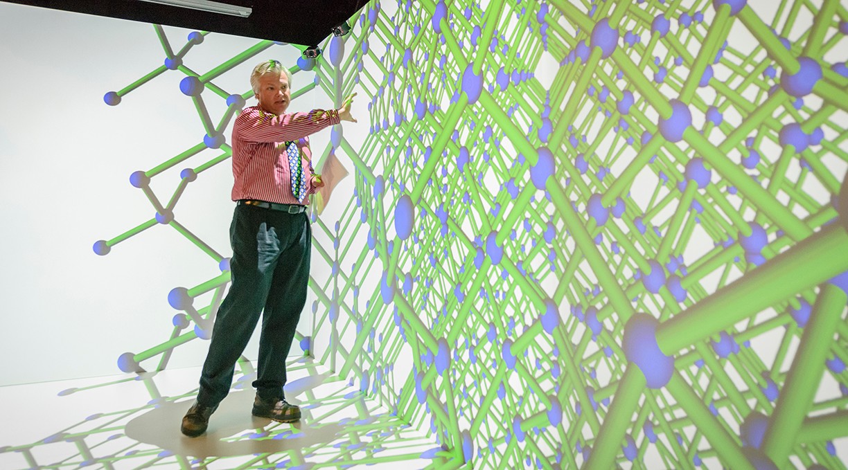 A software engineering professors demonstrates the Villanova CAVE, and immersive virtual reality technology facility