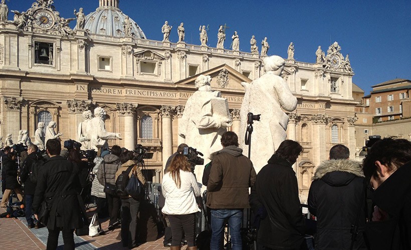 image of interns in front of large ornate building with statues 