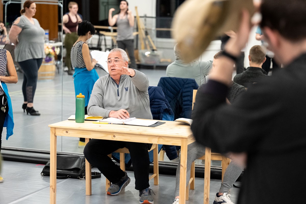 Father Peter directing students in theatre rehearsal.