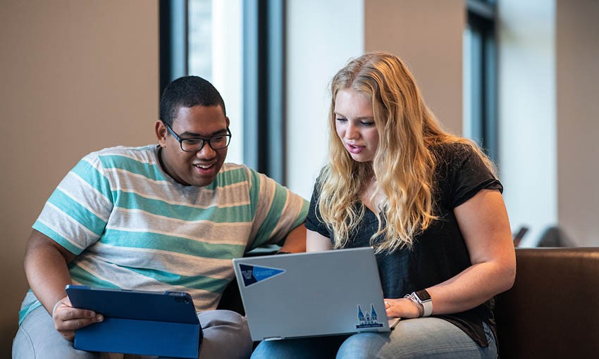 students-looking-at-laptop