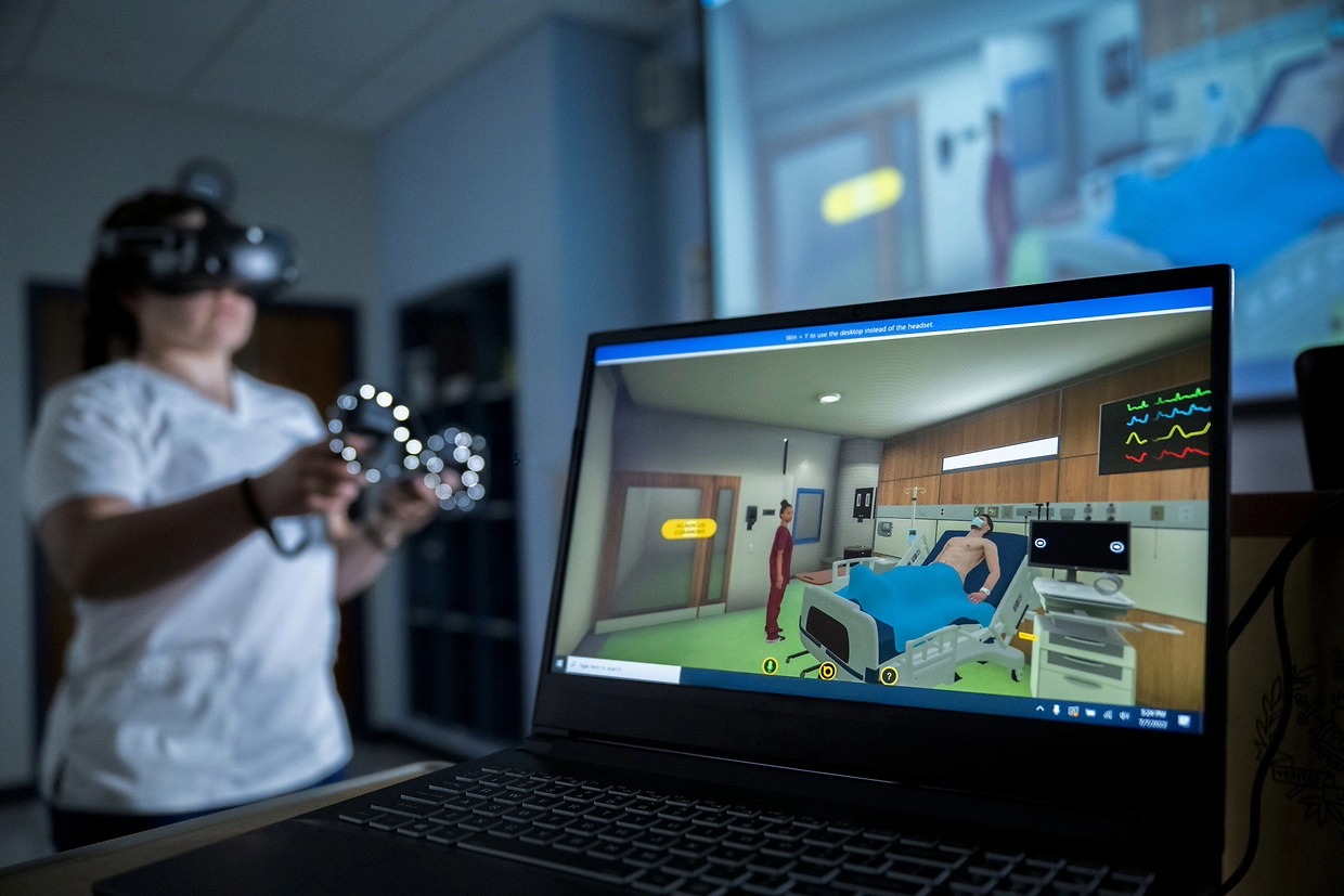 Nursing student using a VR headset in a simulation.