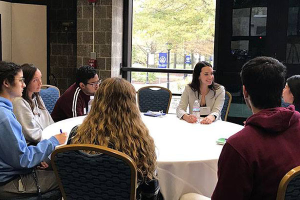 Students and professionals gathered around a table